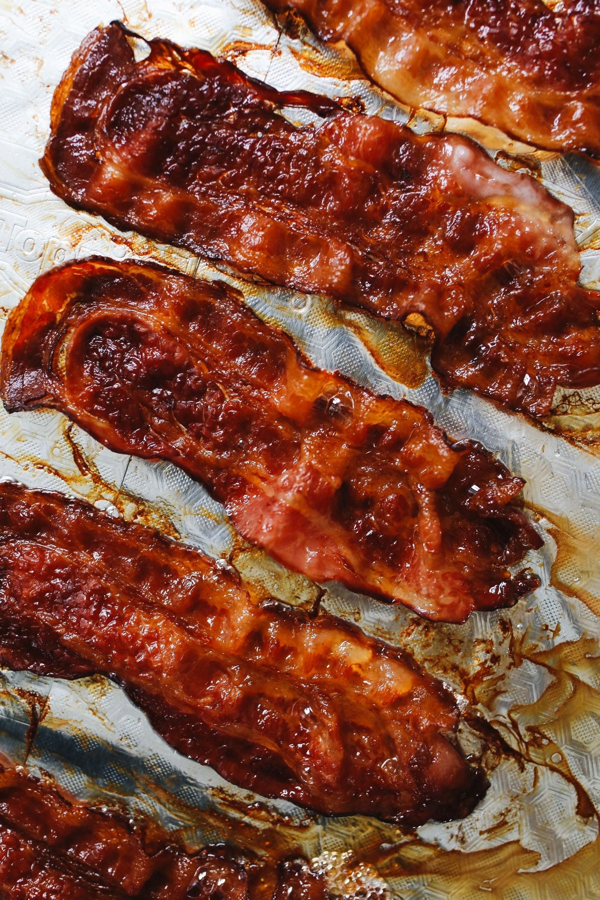 Maple glazed bacon on a baking sheet