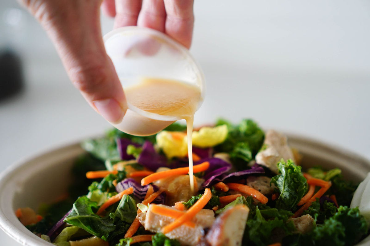 Maple vinaigrette poured over a salad
