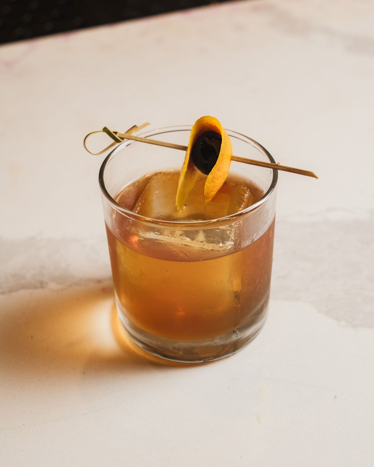 A maple old fashioned with an orange twist
